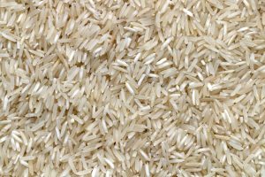 white rice grains on brown wooden table